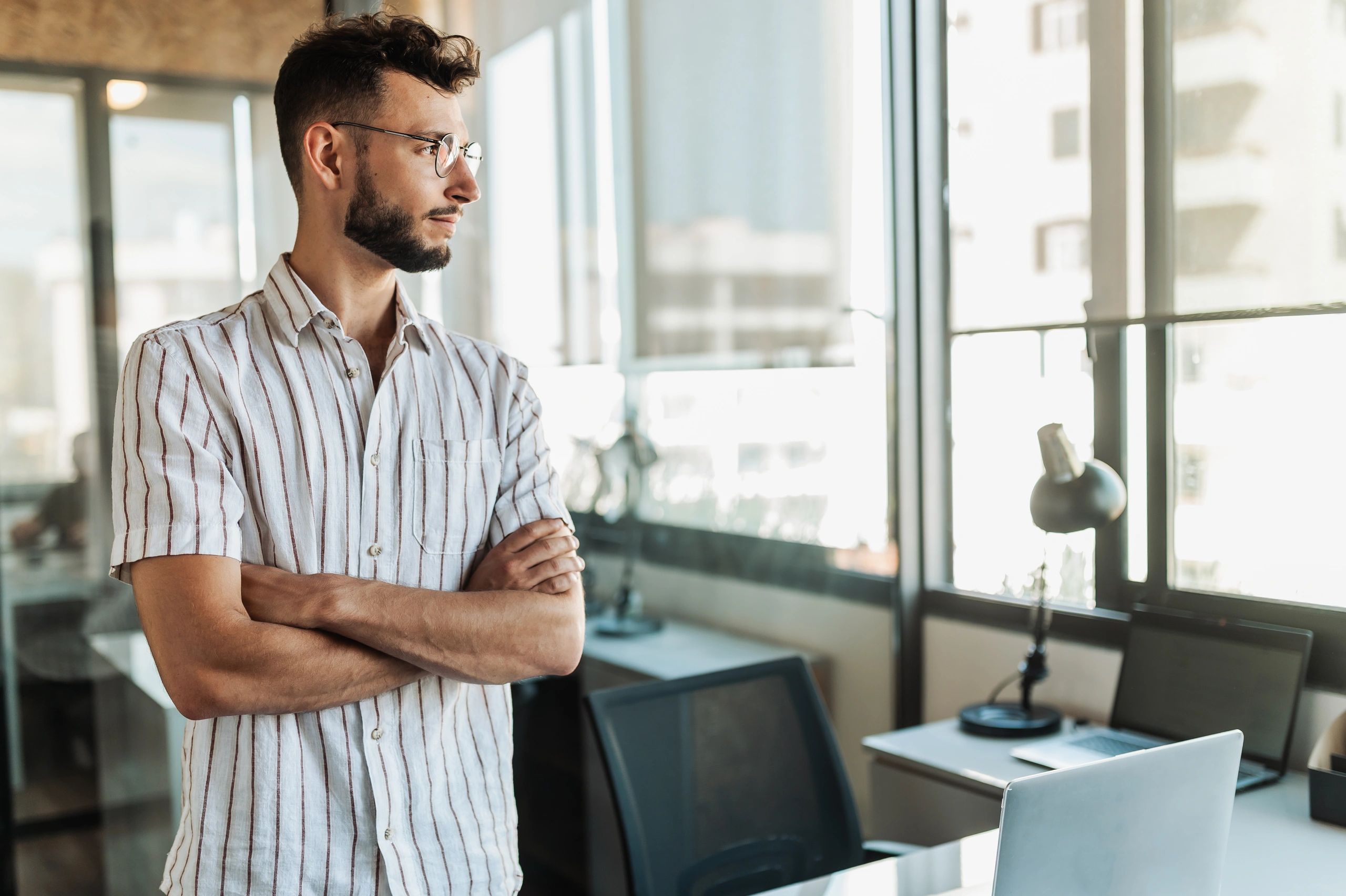 Marketing professional standing confidently in a modern office